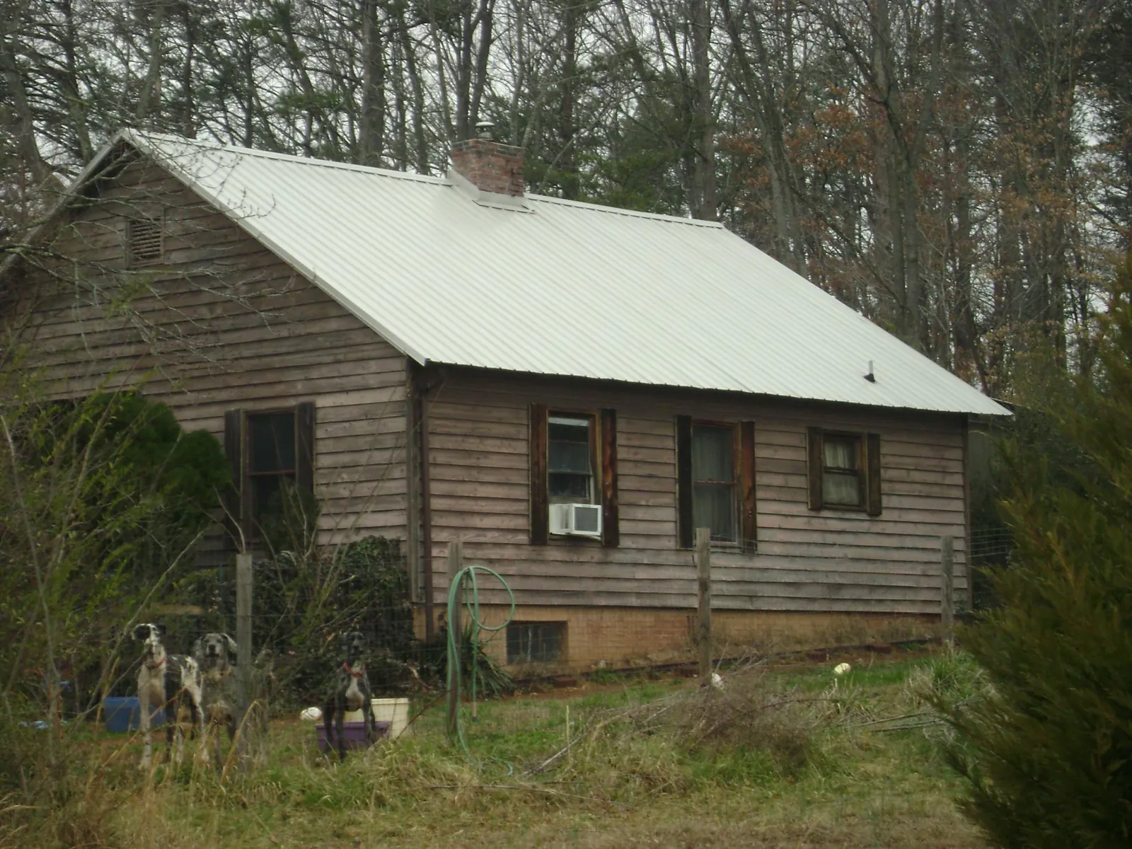 White metal roof on an old wood sided farmhouse in De Soto